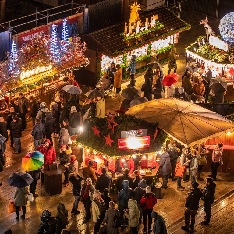 Besucher laufen über den Stuttgarter Weihnachtsmarkt. (Foto: dpa Bildfunk, picture alliance/dpa | Christoph Schmidt)