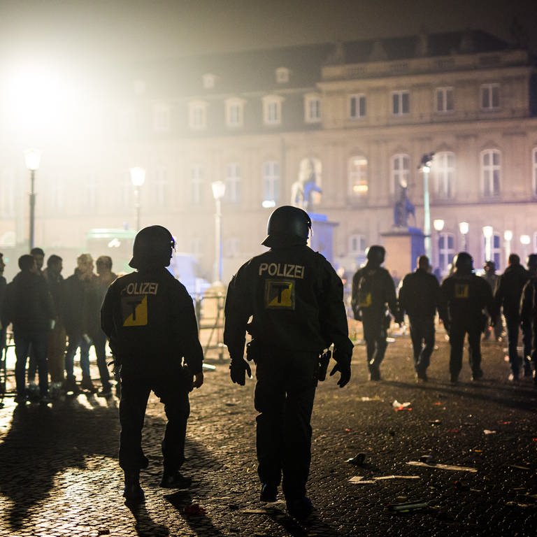 Polizeibeamte gehen in der Silvesternacht über den Stuttgarter Schlossplatz. (Foto: dpa Bildfunk, picture alliance/dpa | Christoph Schmidt)