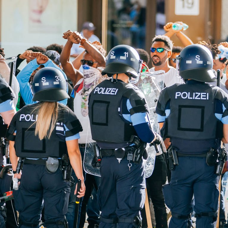 Eine Gruppe von Menschen wird nach Ausschreitungen bei einer Eritrea-Veranstaltung von Polizeikräften eingekesselt. Bis zu 200 Personen hätten Teilnehmer der Veranstaltung und Polizisten mit Steinen, Flaschen und Holzlatten angegriffen, teilte ein Polizeisprecher mit. Zehn Beamte seien verletzt worden.