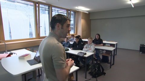 Der Deutschlehrer Till Richter steht vor seiner Klasse 7: Er testet mit den Schülerinnen und Schülern des Gymnasiums in Plochingen ein Modell von Gleitzeit an der Schule. 