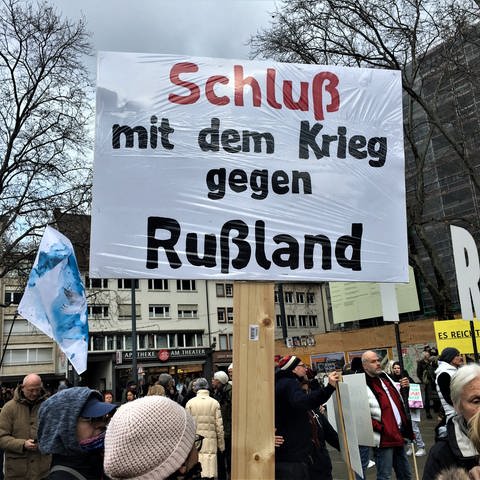 "FreiSeinFreiburg"-Demo: Frau hält Banner mi der Aufschrift "Schluss mit dem Krieg gegen Russland" (Foto: SWR, Gabi Krings)