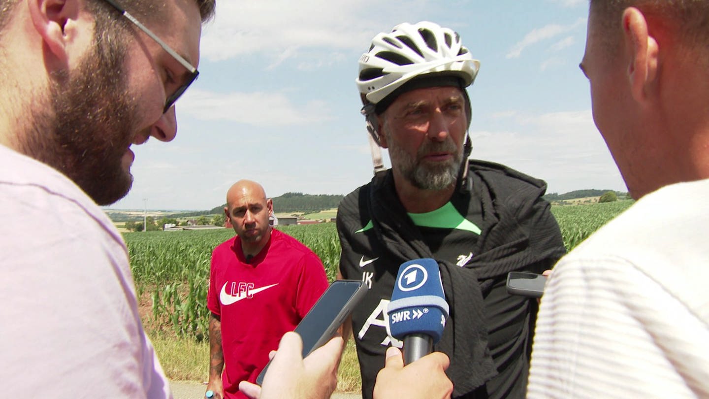 zwei Reporter und ein Mann mit Fahrradhelm (Foto: SWR, Enrico Mock)