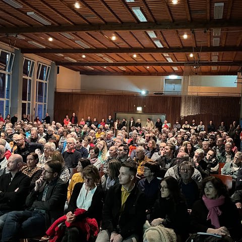 Rund 300 Menschen sitzen im bestuhlten Saal in der Turn- und Festhalle Albstadt-Laufen (Zollernalbkreis) (Foto: SWR)