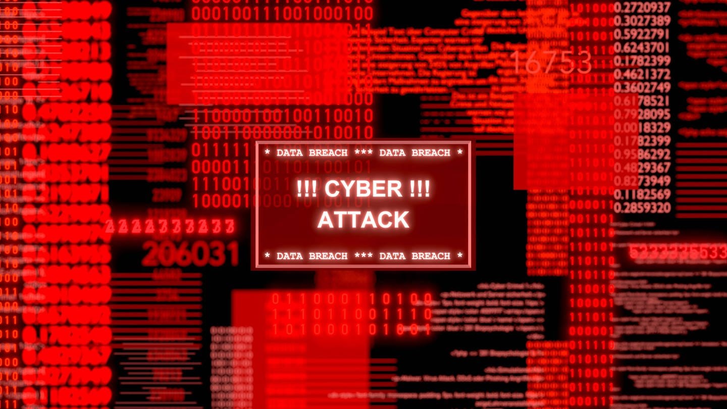 Ein Bildschirm leuchtet rot mit Einsen und Nullen und dem Warnhinweis CyberAttack. Die Cyberattacke auf VARTA Ellwangen hat immer noch Folgen für das Unternehmen. (Foto: IMAGO, Westlight)