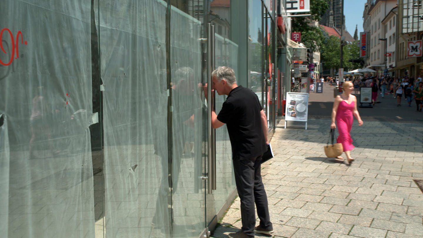 Mann schaut durch Schaufenster Türe eines geschlossenen Geschäft: Auch wenn in der Ulmer Innenstadt viel Leerstand gibt, von Ladensterben kann laut Laden-Aktiv-Manager Norbert Hoffmann nicht die Rede sein. (Foto: SWR, Hannah Schulze)