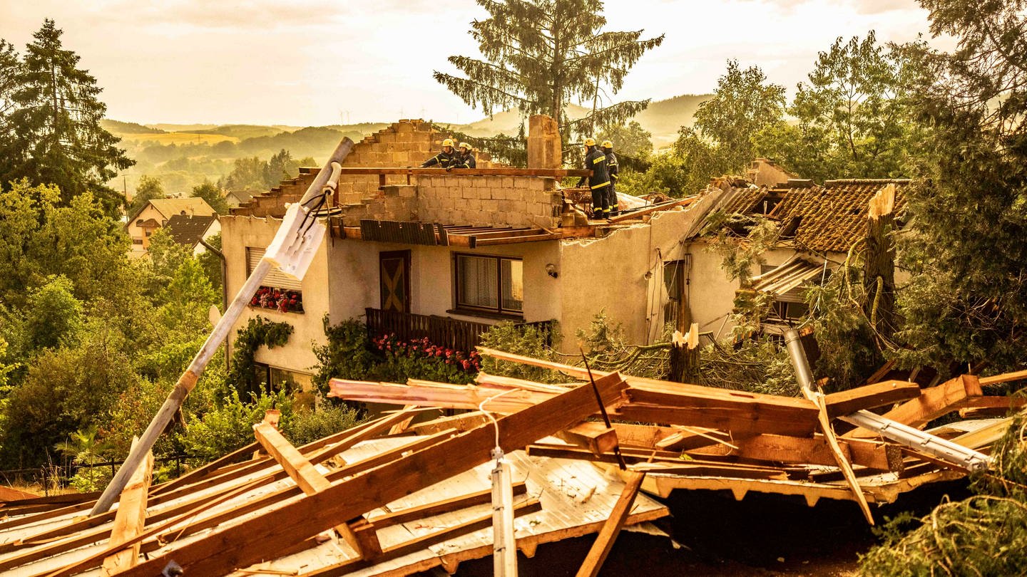 Rettungskräfte arbeiten an einem zerstörten Haus, dessen Dach von einem Sturm abgedeckt wurde. Ein Sturm hat am Dienstagabend in der Gemeinde Freisen im Saarland gewütet. Ob es sich um einen Tornado handelte, war zunächst noch unklar. (Foto: dpa Bildfunk, picture alliance/dpa/Foto Hosser | Christian Schulz)