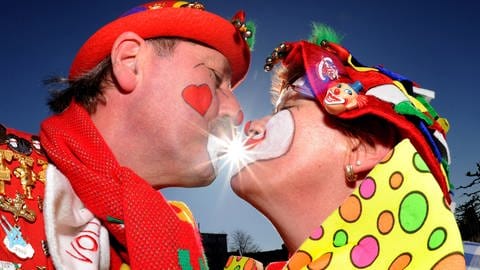 Glückliche Fastnachter küssen sich bei strahlendem Sonnenschein (Foto: dpa Bildfunk, Picture Alliance)