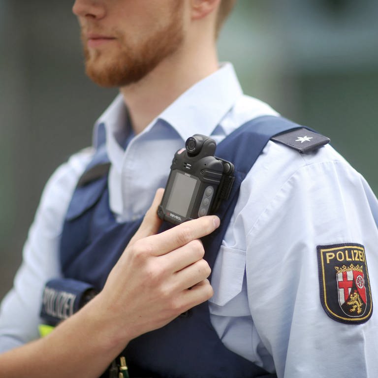 Ein Polizist trägt in Rheinland-Pfalz eine mobile Miniatur-Videokamera an einem Gurt unterhalb seiner Schulter, eine so genannte Bodycam. (Foto: dpa Bildfunk, Picture Alliance)