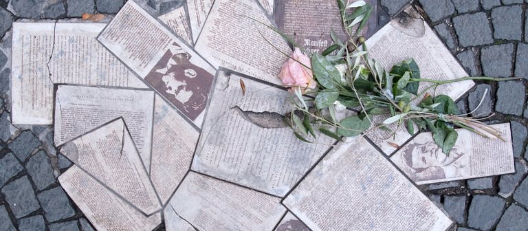  Flugblätter der Widerstandsgruppe "Weiße Rose" sind vor der Ludwig-Maximilians-Universität in München als Denkmal in den Boden eingelassen.  (Foto: dpa Bildfunk, picture alliance/dpa | Sven Hoppe)