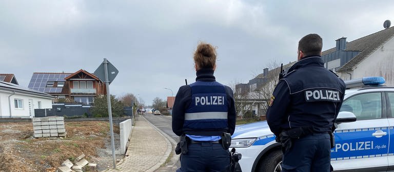 Polizisten vor Polizeiauto in Senbach - Frau erschossen, Ehemann festgenommen (Foto: SWR)