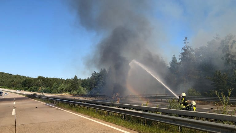 Auf der A6 bei Enkenbach-Alsenborn (Kaiserslautern) hat am Sonntag ein Auto gebrannt. Es kam zu Explosionen die einen Waldbrand un Böschungsbrand auslösten. Die Feuerwehr konnte deshalb zunächst nur aus größerer Entfernung löschen. Die Autobahn war mehrere Stunden voll gesperrt. (Foto: Pressestelle, Polizeidirektion Kaiserslautern)