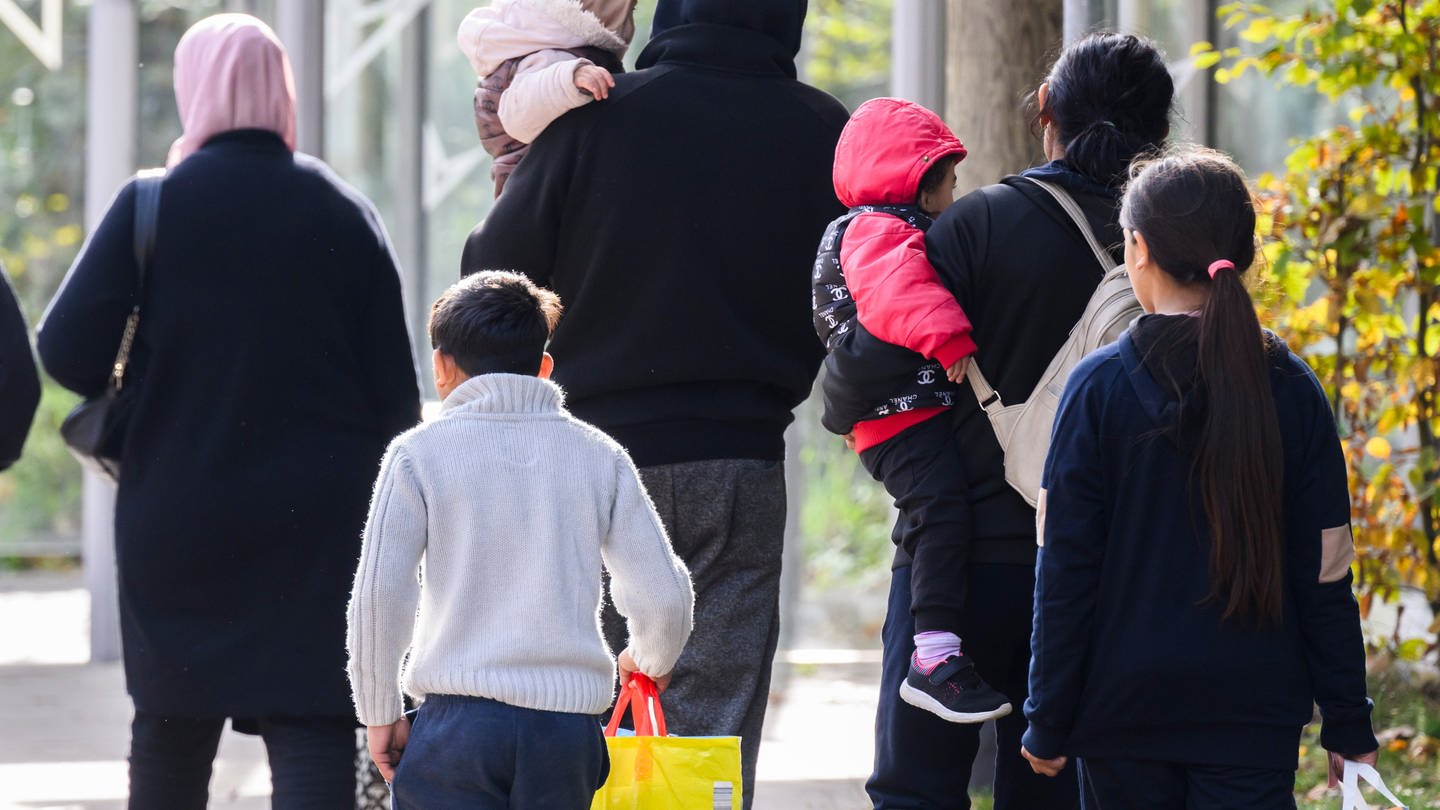 Flüchtlingsfamilie spaziert auf der Straße. (Foto: picture-alliance / Reportdienste, Julian Stratenschulte)