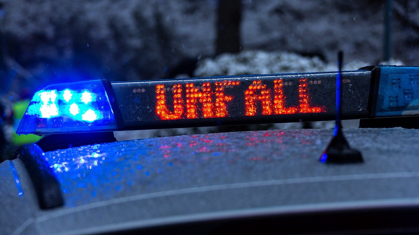 Ein Polizeiwagen mit Blaulicht und LED-Schrift, Unfall, vor verschneiter Landschaft. Bei Perscheid im Husnrück sind ein Auto und ein Linienbus wegen Glatteis zusammengeprallt. (Foto: picture-alliance / Reportdienste, Picture Alliance)