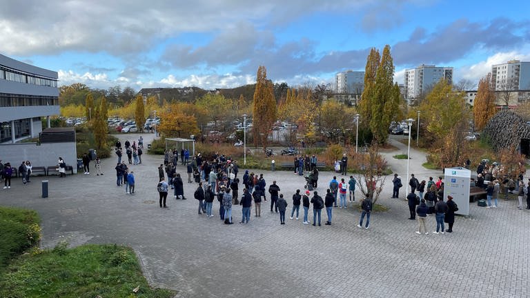 Studenten und Hochschulmitarbeiter stehen auf dem Gelände der Hochschule Koblenz und demonstrieren gegen die geplanten Energiesparmaßnahmen. (Foto: SWR)