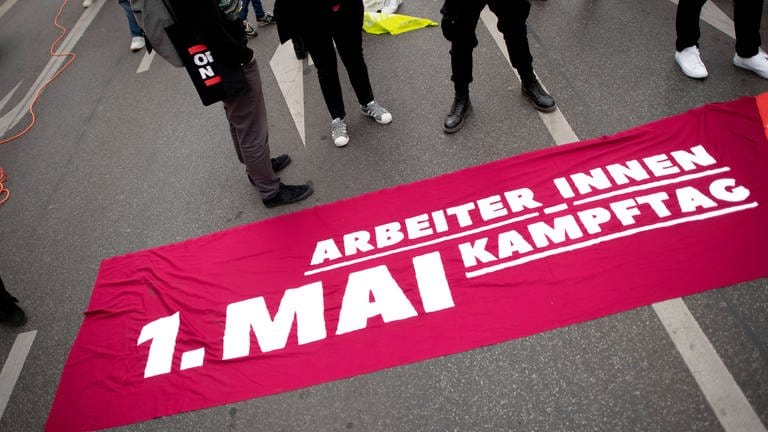 Bundeskanzler Olaf Scholz (SPD) wird am 1. Mai bei der DGB Kundgebung am Deutschen Eck in Koblenz erwartet. Demonstrant mit Transparent Arbeiter:innen Kampftag auf einer Demonstration. (Foto: IMAGO, IMAGO Bildnummer: 0158782360)
