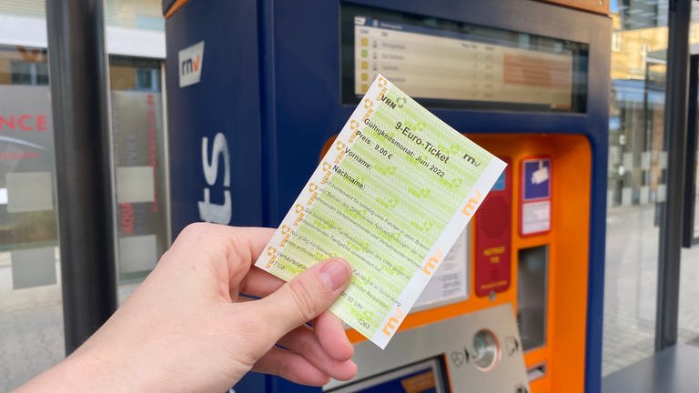 Eine Hand hält ein 9-Euro-Ticket vor einen Fahrscheinautomat.  (Foto: SWR)