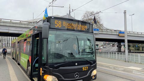 Ein Bus der Mainzer Verkehrsgesellschaft Mainzer Mobilität fährt Mitte März 2022 mit einer Ukraine-Fahne am Bus durch die Stadt. (Foto: SWR, D. Diener)