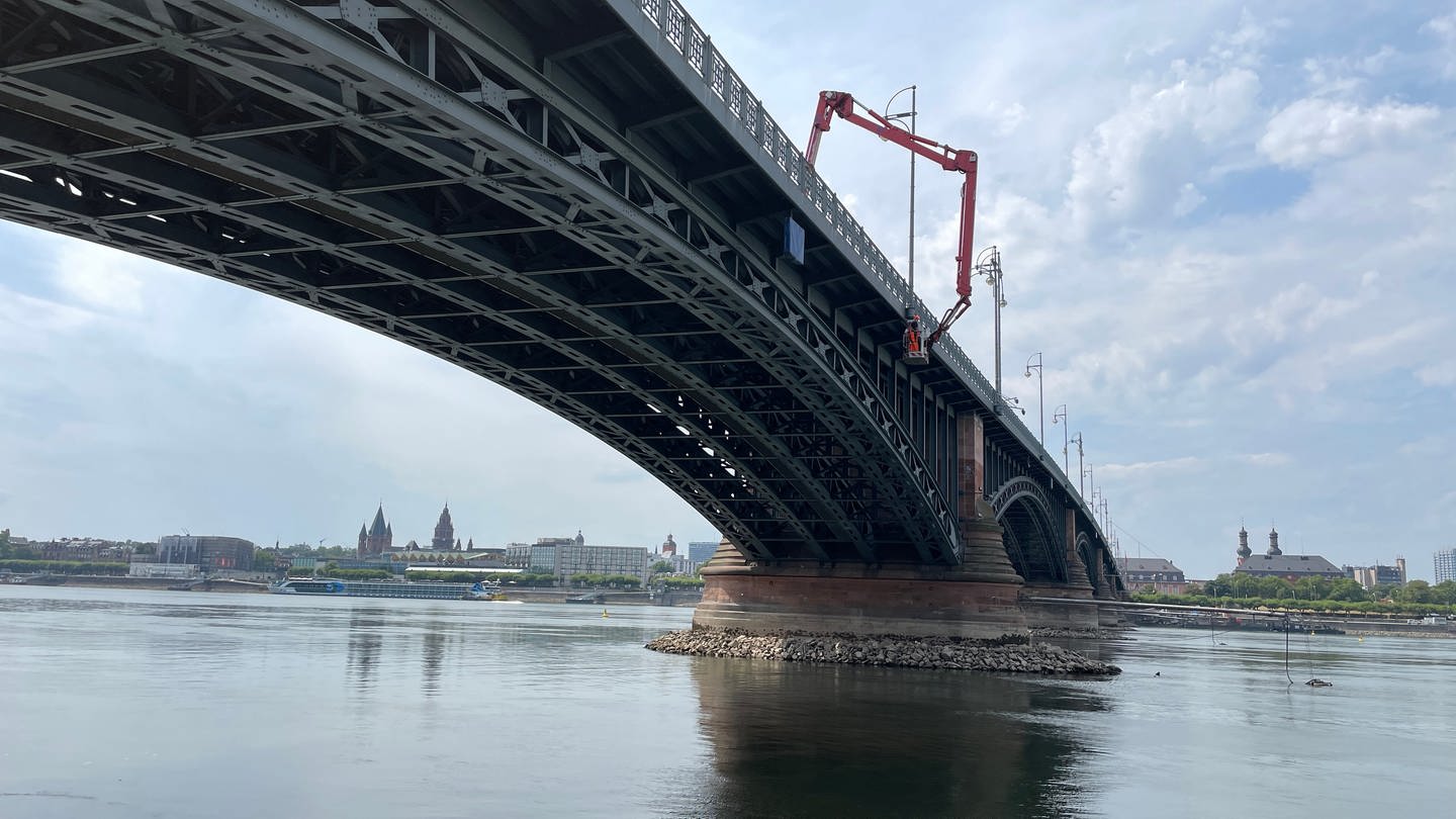 Der Arm eines Krans hängt über der Theodor-Heuss-Brücke in Mainz, sie wird derzeit auf mögliche Schäden untersucht. (Foto: SWR)