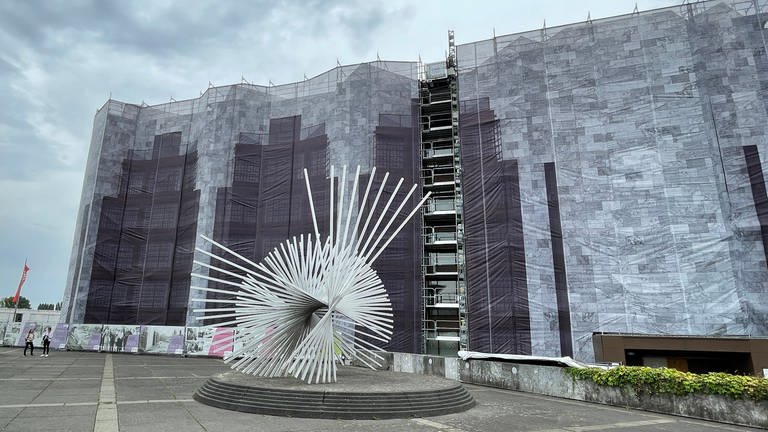 Die graue Fassade des Mainzer Rathauses ist im August 2022 von Baugerüsten umstellt und mit einem Banner verhängt (Foto: SWR, S. Fischer)