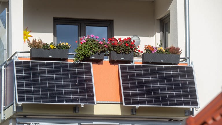 An einem Balkon wurden zwei Solapanele befestigt. Mit der Mini-Photovoltaikanlage kann Strom gewonnen werden. Das spart Energiekosten.  (Foto: Verbandsgemeinde Rhein-Selz)