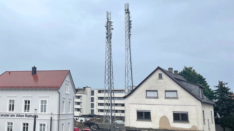 Die neuen Mobilfunkantennen (Masten rechts) in Osthofen funktionieren noch nicht, die alten (links auf dem Schillturm) sind bereits außer Betrieb. Die Gemeinde ist daher seit März vom Mobilfunk abgeschnitten und zu einem großen Funkloch geworden. (Foto: Thomas Goller, Bürgermeister Osthofen)