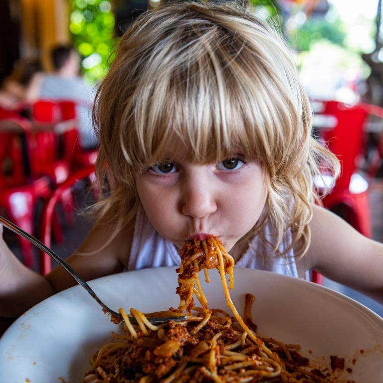 Mädchen isst Spaghetti im Restaurant (Foto: IMAGO, IMAGO / Westend61)