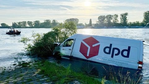 Ein weißer Transporter mit der Aufschrift "dpd" steht zur Seite geneigt im Rhein bei Worms.