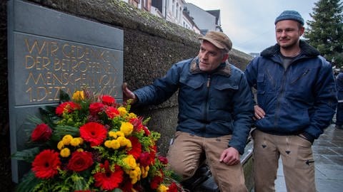 An der Porta Nigra gibt es bereits seit einem Jahr eine Gedenktafel für die Opfer der Amokfahrt. Sie wurde vom Trierer Steinmetz Henning Wirtz (links) erstellt (Foto: dpa Bildfunk, Harald Tittel)