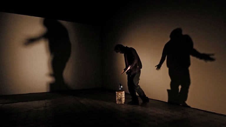 Mann mit Akkuschrauber und Holzblock in einem leeren Raum (Foto: SWR, SWR - Martin Horsky)
