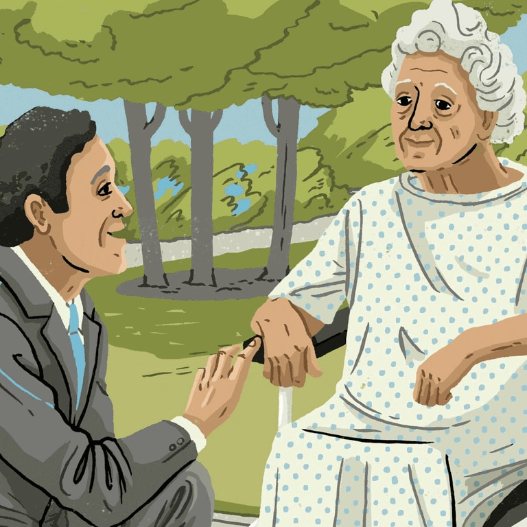 Mann im Anzug spricht mit einer älteren Frau im Rollstuhl  (Foto: IMAGO, xEvaxBeex)