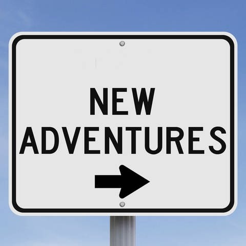 Conceptual road sign on Adventure Symbolfoto