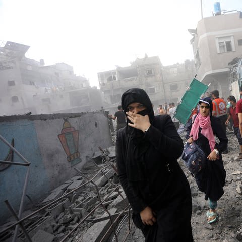 Women flee following an Israeli strike vollowing an Israeli strike in the southern Gaza Strip, as Deadly Israeli Strikes continue for the sixth consecutive day on Thursdy October 12, 2023.