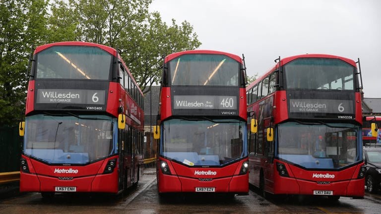Drei rote Londoner Busse mit dem Ziel Willesden stehen nebeneinander.  (Foto: IMAGO, IMAGO / PA Images)