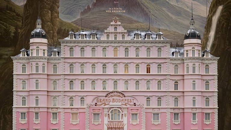 Ein altes, aber luxuriöses Hotel mit pinker Fassade und der Aufschrift "The Grand Budapest Hotel" (Foto: IMAGO, Cinema Publishers Collection)