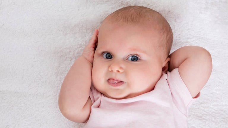 Baby zeigt Zunge: Vom ersten Brabbeln bis zum grammatikalisch korrekten Satz machen Kinder eine komplexe Entwicklung durch