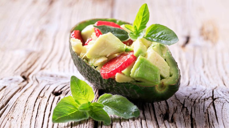 Avocado-Erdbeer-Salat in einer Avocado-Hälfte: Wie umweltschonend ist unser Essen tatsächlich hergestellt?