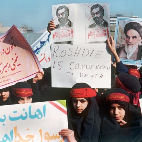 Nachdem der iranische Revolutionsführer Ajatollah Khomeini an alle Moslems den Appell gerichtet hatte, den britisch-indischen Schriftsteller Salman Rushdie zu ermorden, unterstützen Demonstranten in Teheran seinen Mordaufruf. Aufnahme vom 17. Februar 1989. (Foto: picture-alliance / Reportdienste, picture-alliance / dpa | AFP)