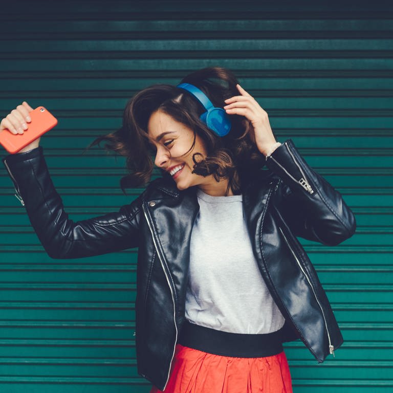 Junge Frau hört Musik und tanzt (Foto: iStock / martin-dm)