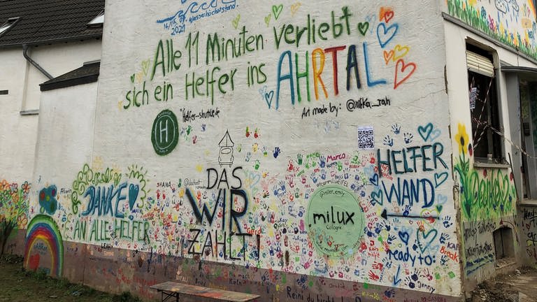Auf eine Hauswand im Ahrtal stehen Botschaften an Helferinnen und Helfer (Foto: SWR)