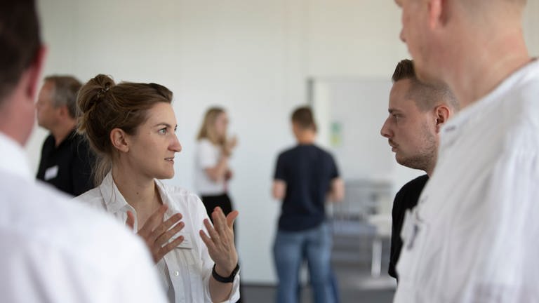 Katharina Schreiber, Innovation Managerin SWR X Lab, im Gespräch mit Beamten der Bundespolizei.