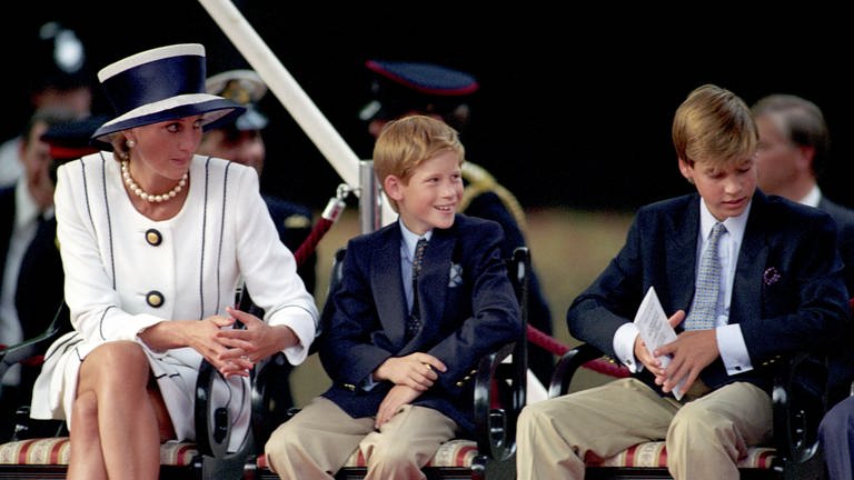 Diana, Prinzessin von Wales, mit Prinz Harry (M.) und Prinz William bei Feierlichkeiten zum VJ-Tag 1985.