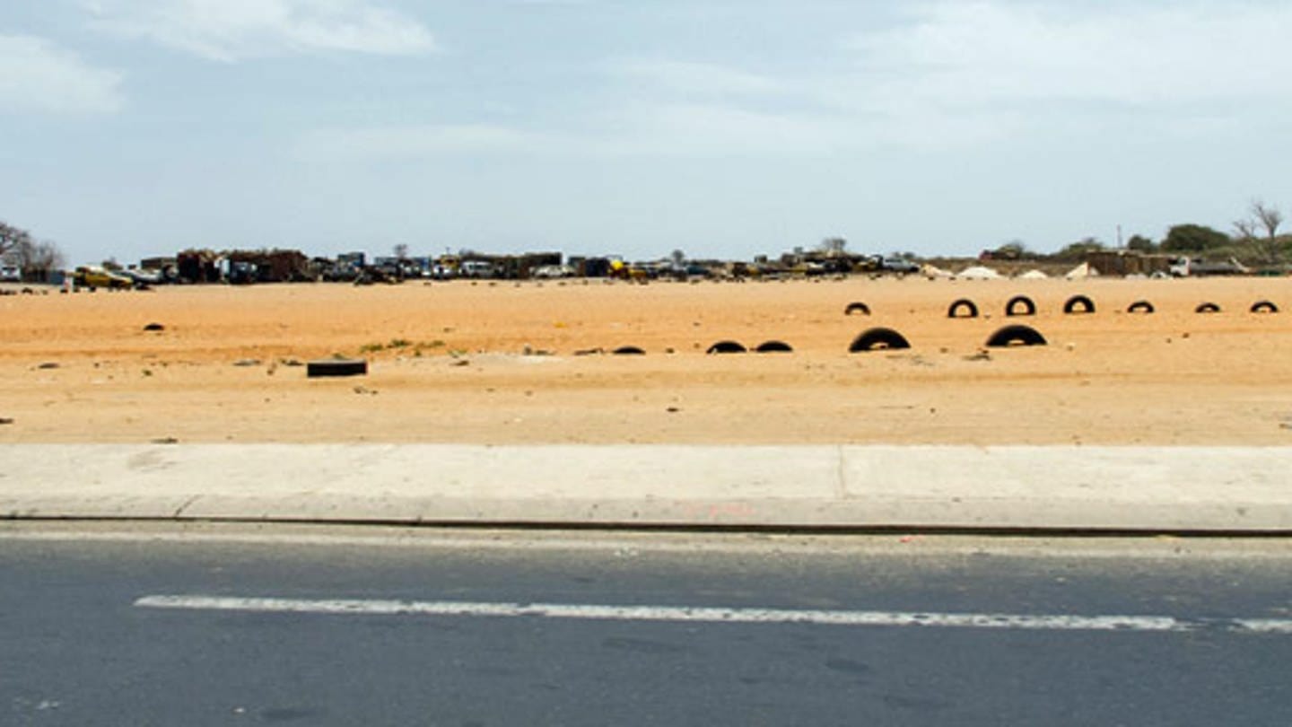 Autoreifen im Sand: Die Hörerin hat das Foto zur Veranschaulichung mitgeschickt. Die Reifen dienen in trockenen Ländern wie hier im Senegal zur Abrengzung von Feldern oder Sportplätzen (Foto: SWR)