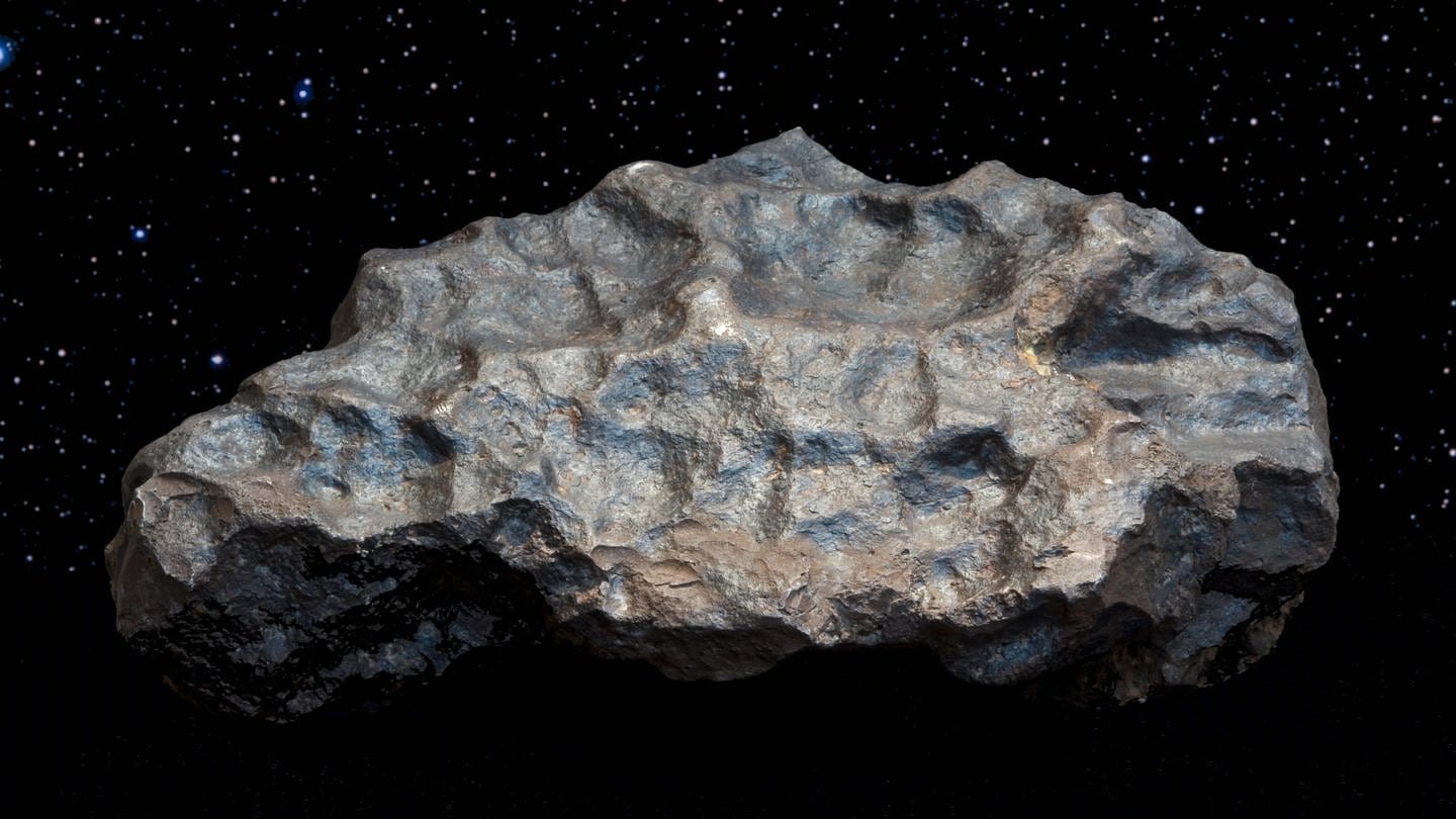 Der Meteorit von Colomera: Meteoriten sind Objekte, die aus dem Weltall kommen. Sie sind mit hoher Geschwindigkeit durch die Erdatmosphäre gesaust, etwa 70 Kilometer pro Sekunde. Meteoriten zeichnen sich meist dadurch aus, dass sie eine schwarze, glänzende Haut haben. (Foto: dpa Bildfunk, picture alliance / MNCN/dpa)