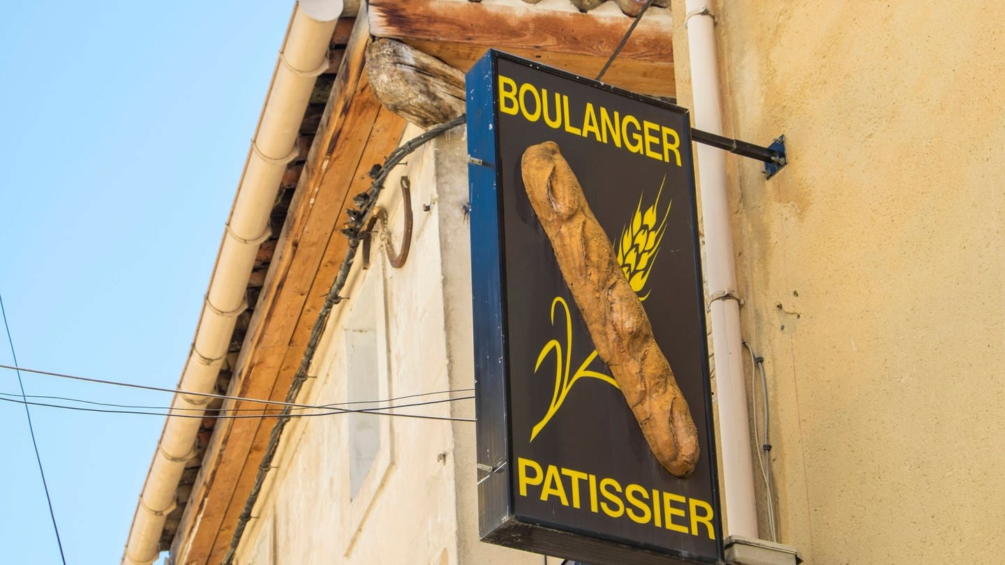 An einer französischen Bäckerei hängt ein Schild mit der Aufschrift 