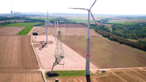 Diese Fotomontage zeigt das vertikale Windkraftrad Vertical Sky® A 32 auf dem Windtestfeld im Vergleich zu herkömmlichen Windrädern. (Foto: Pressestelle, agilewindpower.com / Vertical Sky®)