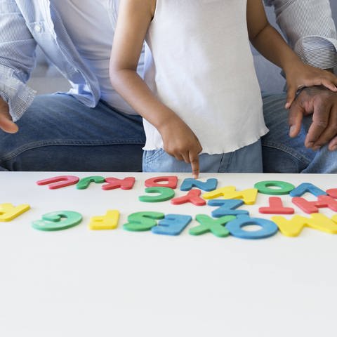 Vater und Tochter bei einem Buchstabenspiel (Foto: IMAGO, Sus Pons via www.imago-images.de)