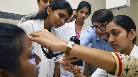 Am Sankara Eye Hospital in Bangalore schult Dr. Maximilian Wintergerst (Mitte) augenärztliches Hilfspersonal in der Smartphone-basierten Funduskopie. (Foto: Universität Bonn/Sankara Eye Foundation)
