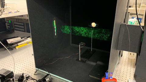 In diesem Versuch wurde mit Hilfe von Laserlicht sichtbar gemacht, wie lange sich Aerosole in der Luft halten können. (Foto: Pressestelle, Stanford University)
