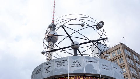 Die Weltzeituhr auf dem Alexanderplatz mit dem Berliner Fernsehturm im Hintergrund (Foto: IMAGO, imageBROKER/StephanxSchulz iblsns10214933.jpg)
