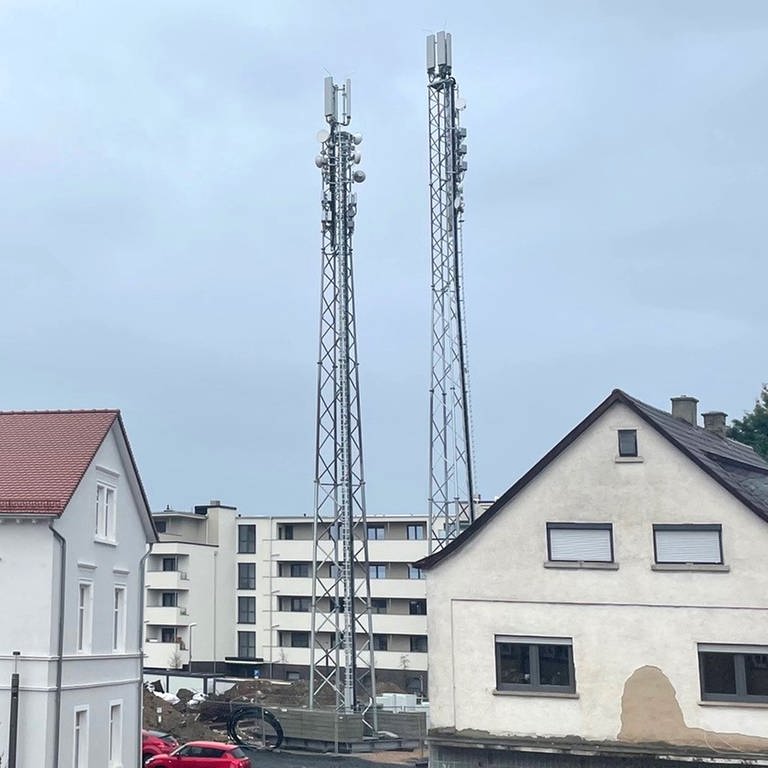 Die neuen Mobilfunkantennen (Masten rechts) in Osthofen funktionieren noch nicht, die alten (links auf dem Schillturm) sind bereits außer Betrieb. Die Gemeinde ist daher seit März vom Mobilfunk abgeschnitten und zu einem großen Funkloch geworden. (Foto: Thomas Goller, Bürgermeister Osthofen )